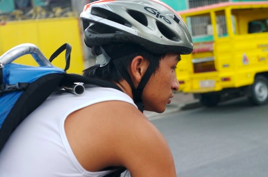 Joash riding in traffic wearing his helmet