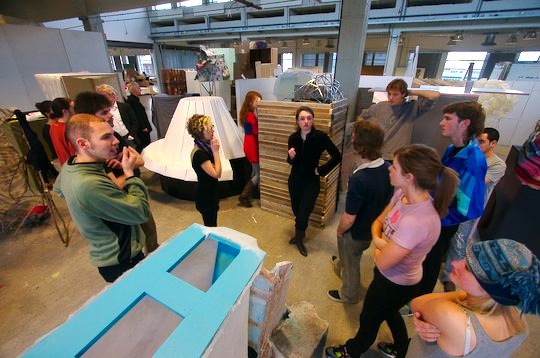 Design students stand around in the studio making decisions