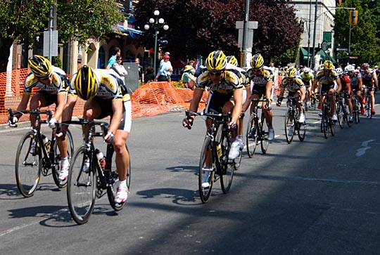 A pack of bike racers race towards us