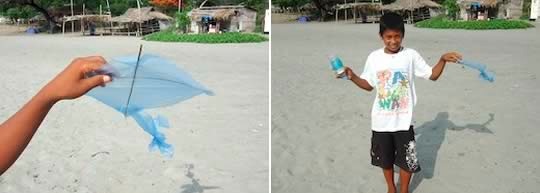 Boy with his homemade kite out of a plastic bag and twigs