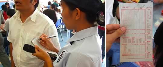 A fast food restaurant employee taking orders in line