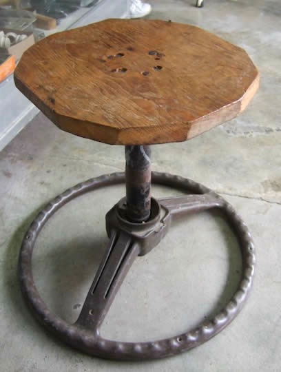 A stool made of a steering wheel and wood