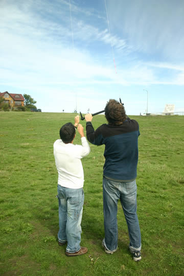 Two guys fly a kite