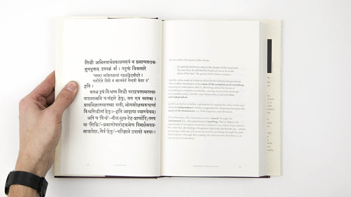 Interior spread of hard cover book showing sutra on left, text on right